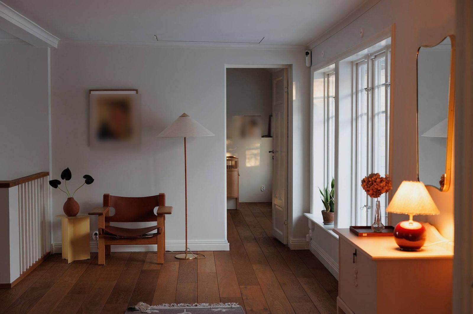 The sunlit upstairs landing with Spanish chair and brass lamp