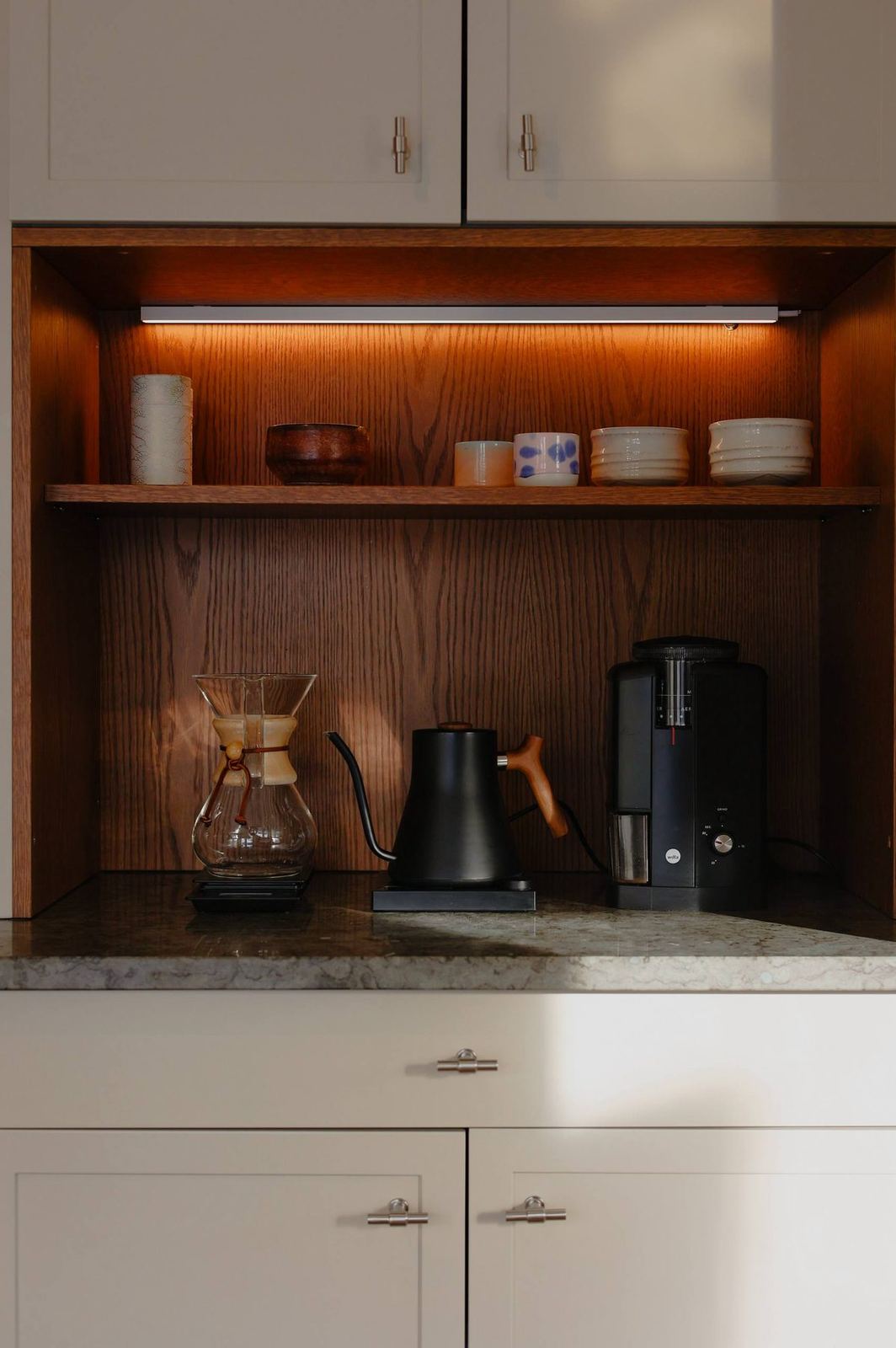 Oak coffee nook with warm under-shelf lighting